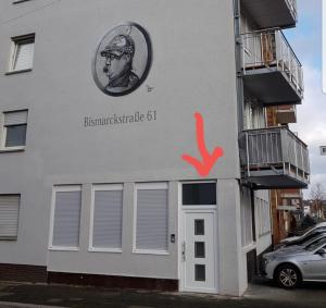 a building with a sign on the side of it at Bismarck-Apartment in Kaiserslautern