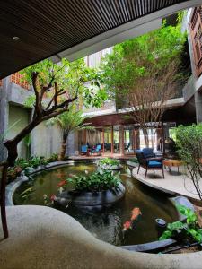 a koi pond in the middle of a building at Minh Boutique in Danang