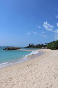 a sandy beach with the ocean in the background at Colonial Surfing Villa Hostel & Home Stay in Midigama