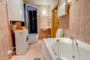 a bathroom with a tub and a sink at Luxury Suites - Antique with Sauna in Tallinn