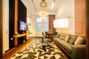 a living room with a couch and a table at Matei Corvin Deluxe Apartment in Cluj-Napoca