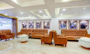uma sala de espera com sofás, mesas e quadros em Treebo Trend The Pavilion em Nagpur