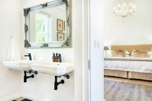 
a bathroom with a sink and a mirror at Maison Montagne in Franschhoek
