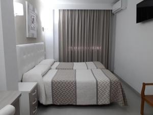 Ліжко або ліжка в номері Hotel Goya