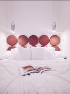 a bedroom with a white bed with a book on it at Rost Apartments in Bielsko-Biała