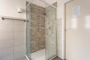 a shower with a glass door in a bathroom at Da Gianni e Lucia Rooms with bathroom in the city center in Catania