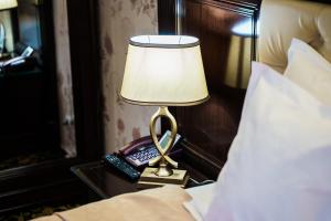 Postel nebo postele na pokoji v ubytování Grand Hotel Orient Braila