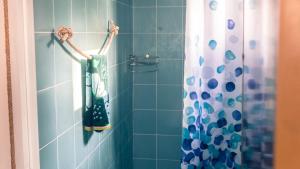 a blue bathroom with a shower with a shower curtain at Blue Moon Beach Hut in Ko Phangan