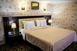 Postel nebo postele na pokoji v ubytování Grand Hotel Orient Braila