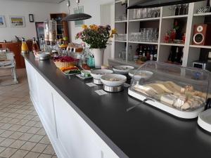 a kitchen with a counter with food on it at Ferienwohnungen Moenchgut und Ruegen in Lobbe