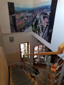 a view from the stairs of a building with a picture on the wall at Alex Pension in Prešov