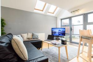 a living room with a couch and a table at City Retreat, 2 Bed House with Cloudstream Hot Tub in Cardiff