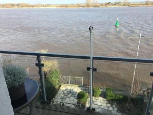 a balcony with a view of a lake at Hotel Ambiente in Brake