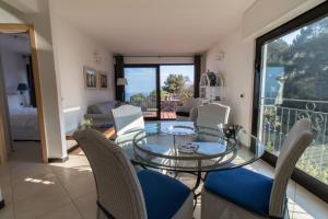 a dining room with a glass table and chairs at Casa Bellavista in Diano Marina