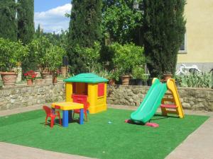 a playground with different colored play equipment on grass at Ginestra in Poggibonsi