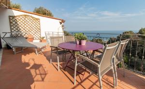 a patio with a table and chairs on a balcony at Casa Bellavista in Diano Marina +6 photos