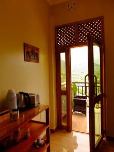 a kitchen with a door open to a balcony at Enjivai Hostel in Arusha