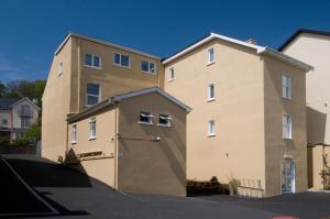 a building with a large garage in front of it at Beach Haven Apartments in Tramore