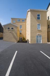 
a large brick building with a large window at Beach Haven Apartments in Tramore
