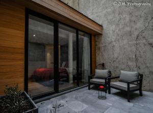 two chairs and a table on a patio with a bedroom at James & Leon in Ostend