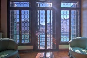 a room with two chairs and stained glass windows at RABOSO Grand 9-windows in Venice