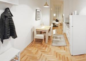 a kitchen and dining room with a table and a refrigerator at Luxury new cozy flat at Dob street nearby Gozsdu court in Budapest