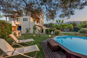 a villa with a swimming pool and a house at Malena Organic Farm in Episkopí- Rethimno