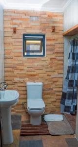 a bathroom with a toilet and a sink at Upland Estates Serviced Apartments in Lusaka