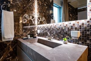 bagno con lavandino e specchio di The Gate Boutique Hotel Zürich a Glattbrugg