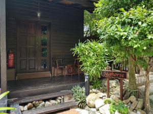 a porch of a house with a sign in front of it at Ombak Dive Resort Perhentian Island in Perhentian Islands