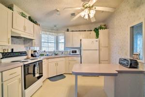 a kitchen with white appliances and a ceiling fan at Fishing Paradise with Deck and Dock on Suwannee River in Branford