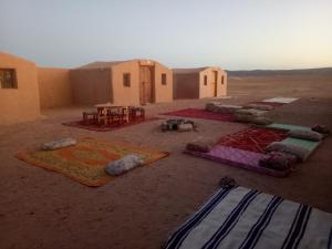 a group of tents in the middle of the desert at Sahara Peace in Mhamid