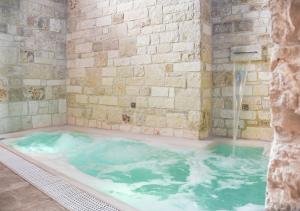 a jacuzzi tub with a water fountain at Trulli e Puglia Luxury Suite in Alberobello
