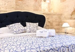 a bedroom with a bed with two towels on it at Trulli e Puglia Luxury Suite in Alberobello