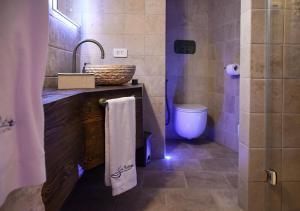 a bathroom with a sink and a toilet at Trulli e Puglia Luxury Suite in Alberobello