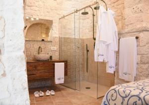 a bathroom with a shower and a sink at Trulli e Puglia Luxury Suite in Alberobello
