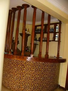 a bar with a bunch of bottles on a wall at Bright Star Hotel in Arusha