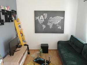 a living room with a green couch and a map of the world at Apartment Luna in Tisno