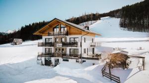 a large house in the snow with snow at Appartements Almnest in Schladming