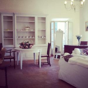 a living room with a white table and a couch at Clockwise in Viterbo