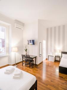 a room with a bed and a desk in it at Piazza Cavour Suite in Rome