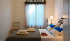 a bedroom with a bed with towels on it at Anima Apartments in Chora Folegandros