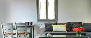 a living room with a couch and a table at Anima Apartments in Chora Folegandros