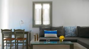a living room with a couch and a table at Anima Apartments in Chora Folegandros