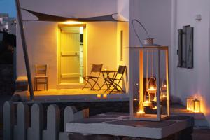 a small house with a table and chairs on a patio at Anima Apartments in Chora Folegandros