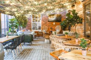 a restaurant with tables and chairs and a brick wall at Saint Pauls House in Birmingham