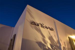 a sign on the side of a white building at Anima Apartments in Chora Folegandros