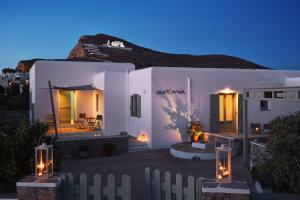 a white house with a fence in front of it at Anima Apartments in Chora Folegandros