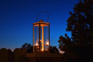 a lantern hanging on a fence at night at Anima Apartments in Chora Folegandros