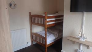a bunk bed in a small room with a bunk bed at The Victoria guest house in Mablethorpe